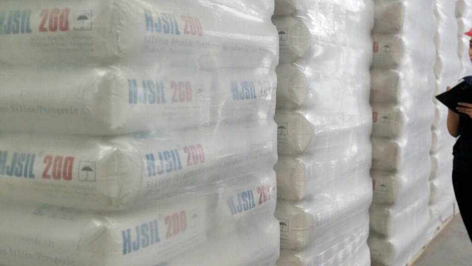 Stacks of bags labeled "HJSIL 200" containing silica product.